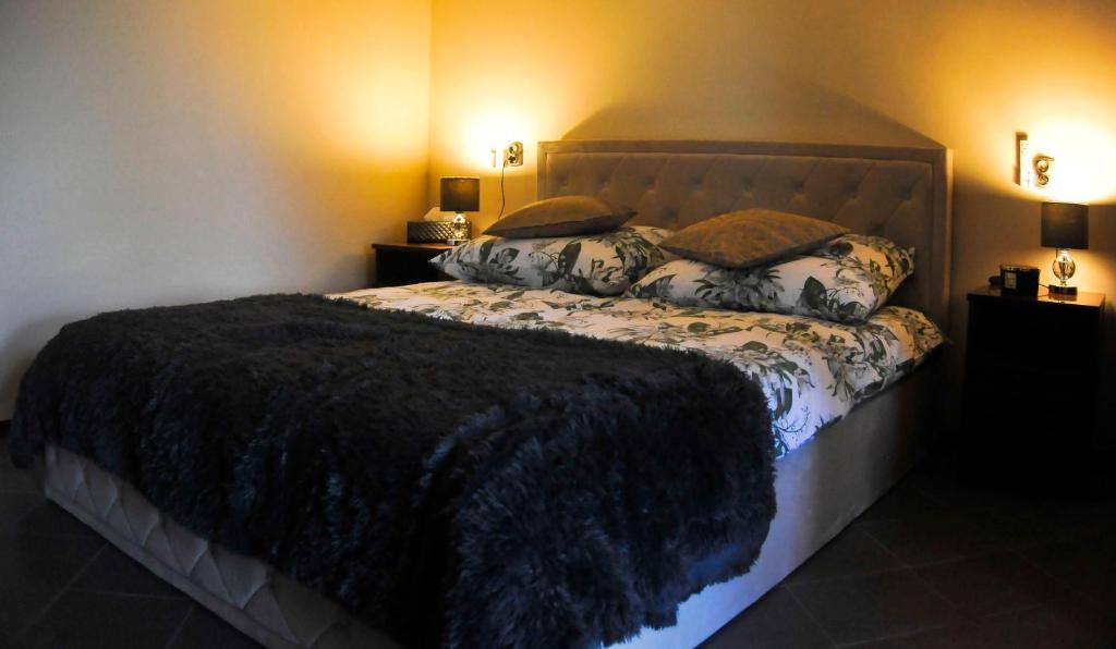 a bedroom with a large bed with two pillows at Apartament Cristina in Mosty