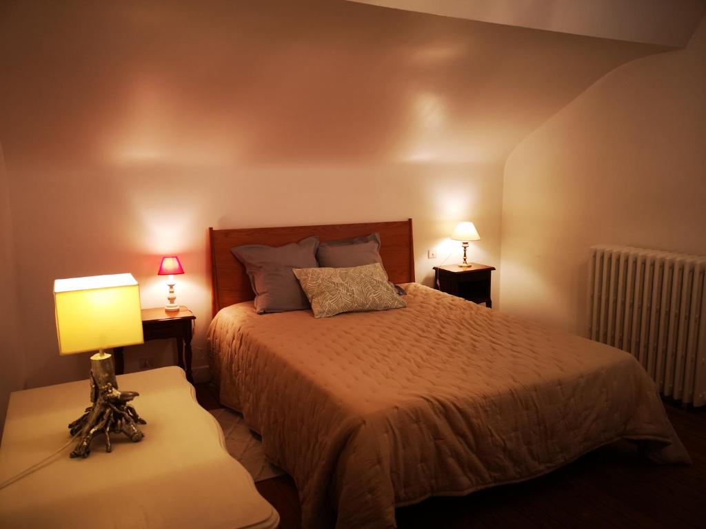 - une chambre avec un lit et 2 tables avec des lampes dans l'établissement Le Polygone, au Mans