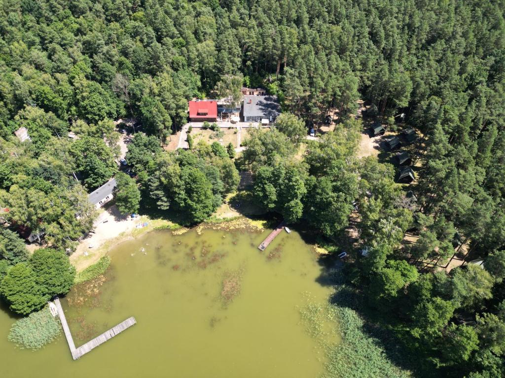 an aerial view of a house in the middle of a lake at JABŁONKOWY LAS Stanica Wodna PTTK in Stare Jabłonki