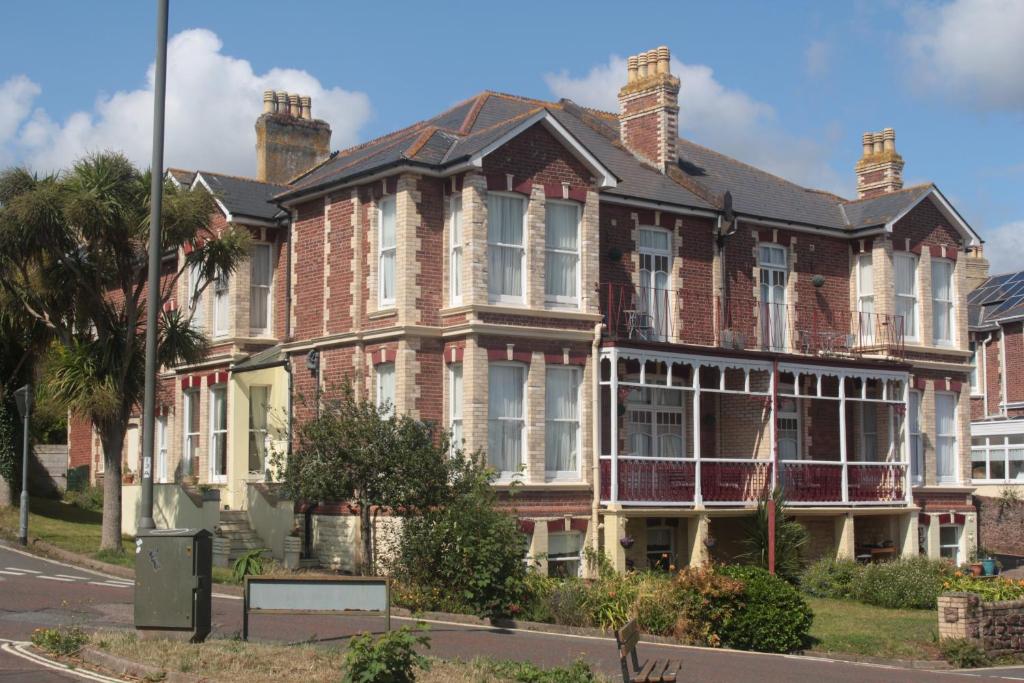 a large brick house on a city street at Cleve Court Hotel in Paignton