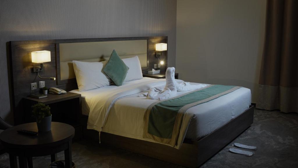 a hotel room with a bed with towels on it at Tu Jardin Al Marwa- توجاردن المروه in Jeddah