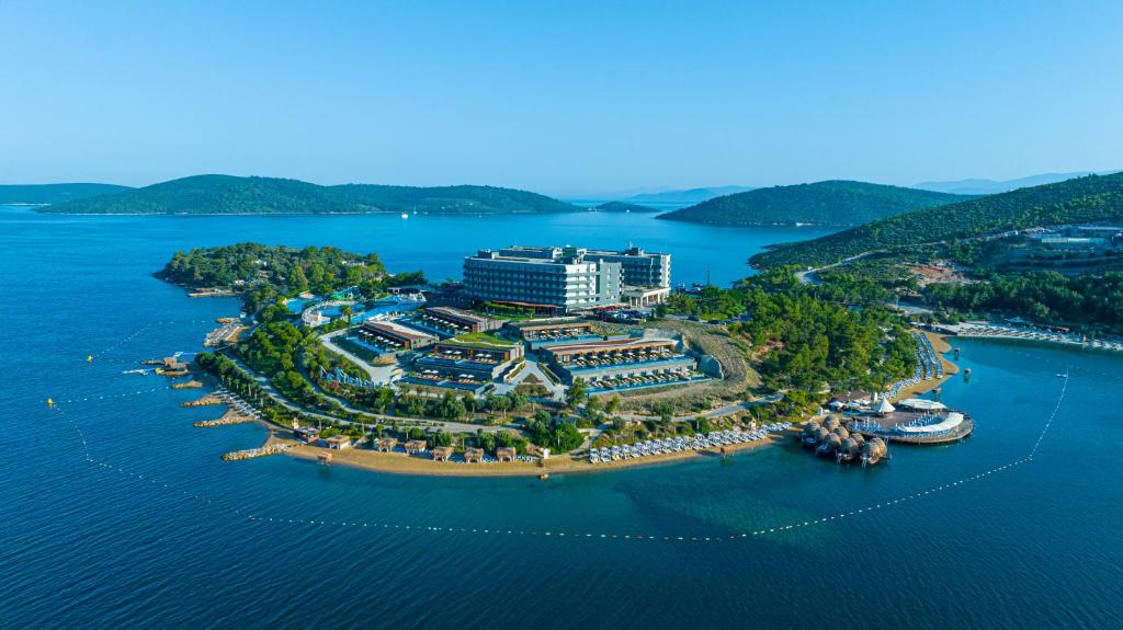 an aerial view of a resort on a island in the water at La Blanche Island Bodrum in Guvercinlik