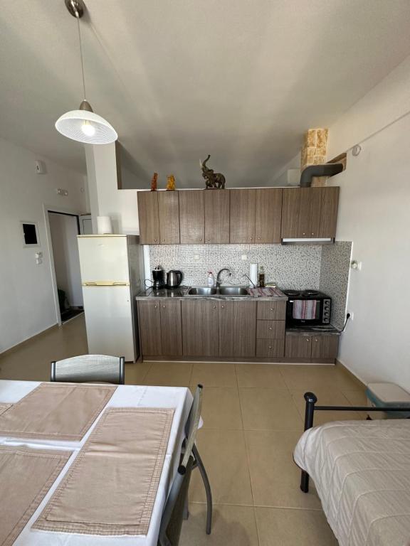 a kitchen with a sink and a table in a room at House With View in Paránimfoi