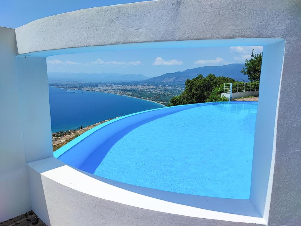 a swimming pool with a view of the water at Ryalos Villas in Kalamata