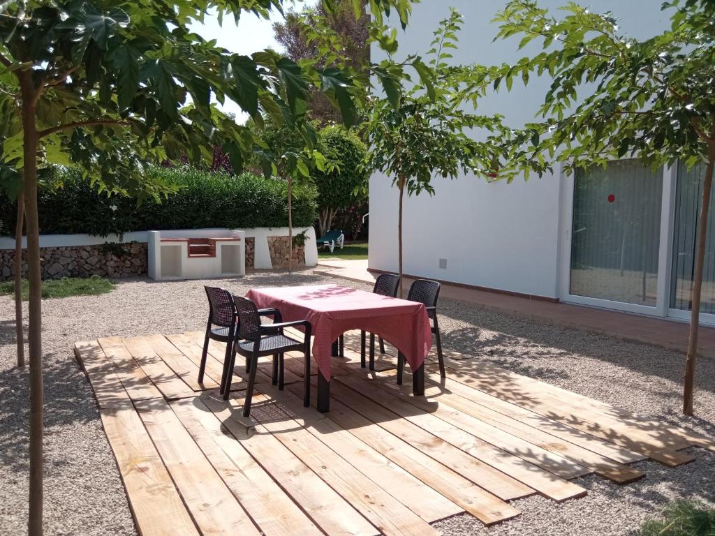 a table and chairs sitting on a wooden deck at Villa Piscis in Cala Blanca