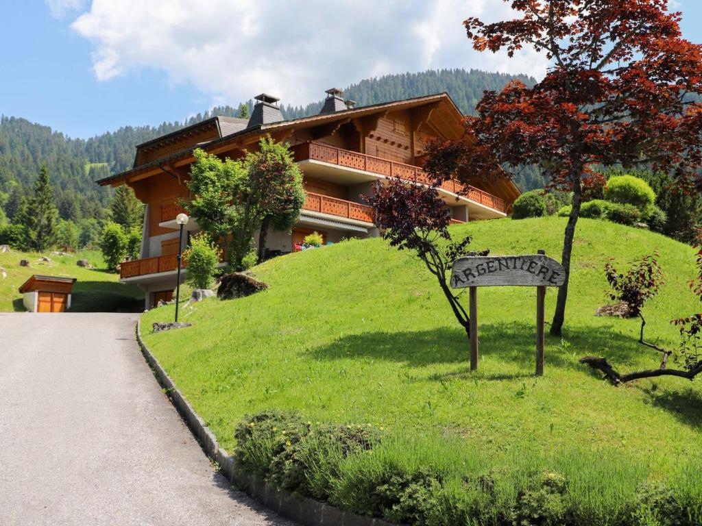 a sign in the grass in front of a house at Apartment Argentière 3 by Interhome in Villars-sur-Ollon