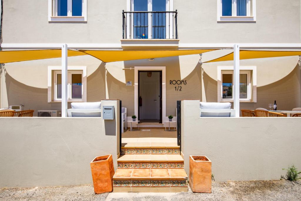 a entrance to a building with a yellow umbrella at CASA 4YOU in Carvoeiro