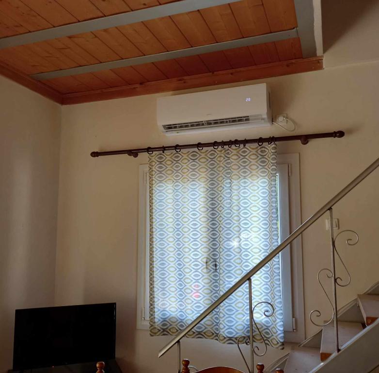 a room with a window with a air conditioner at Kalloni Village House in Kalloni