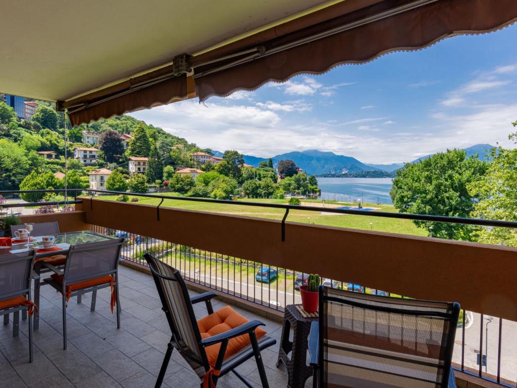 een balkon met uitzicht op een rivier en de bergen bij Apartment Gaggetto - LVM160 by Interhome in Laveno-Mombello