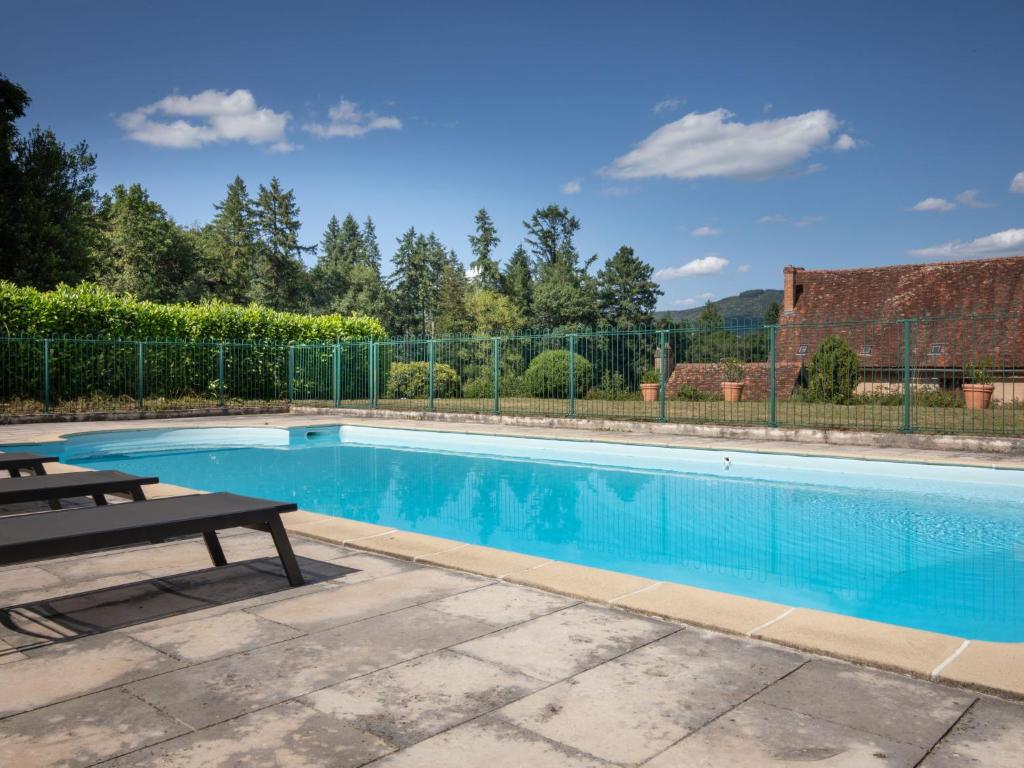 a swimming pool with a picnic table next to a fence at Holiday Home La Maison du Chateau by Interhome in La Tagnière