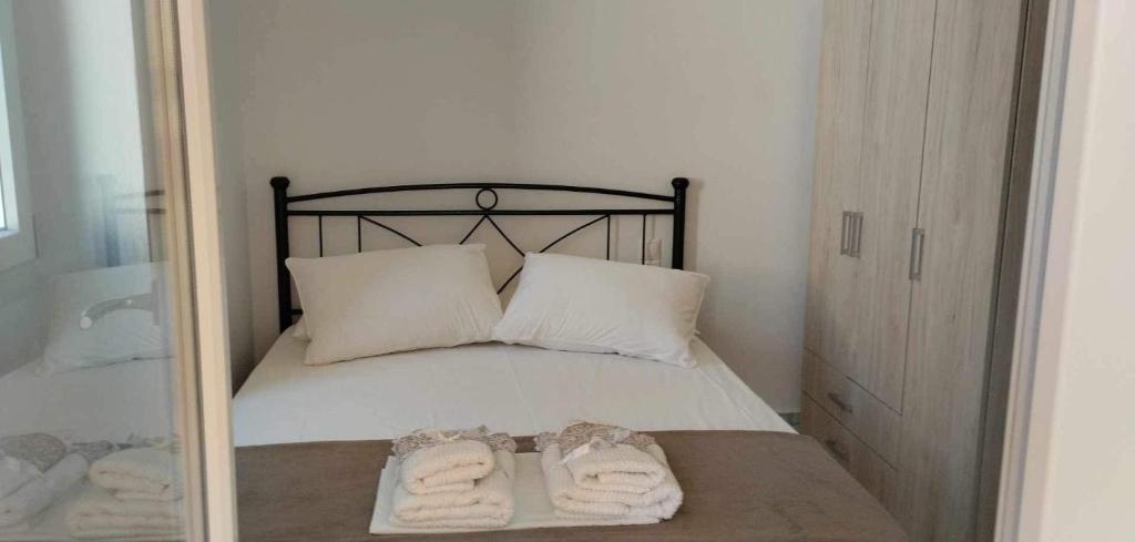 a bedroom with a bed with two towels on it at Diakofti house by the sea - Kythoikies hoilday houses in Kythira