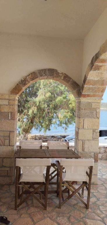 a table in a room with a stone wall at Diakofti house by the sea - Kythoikies hoilday houses in Kythira