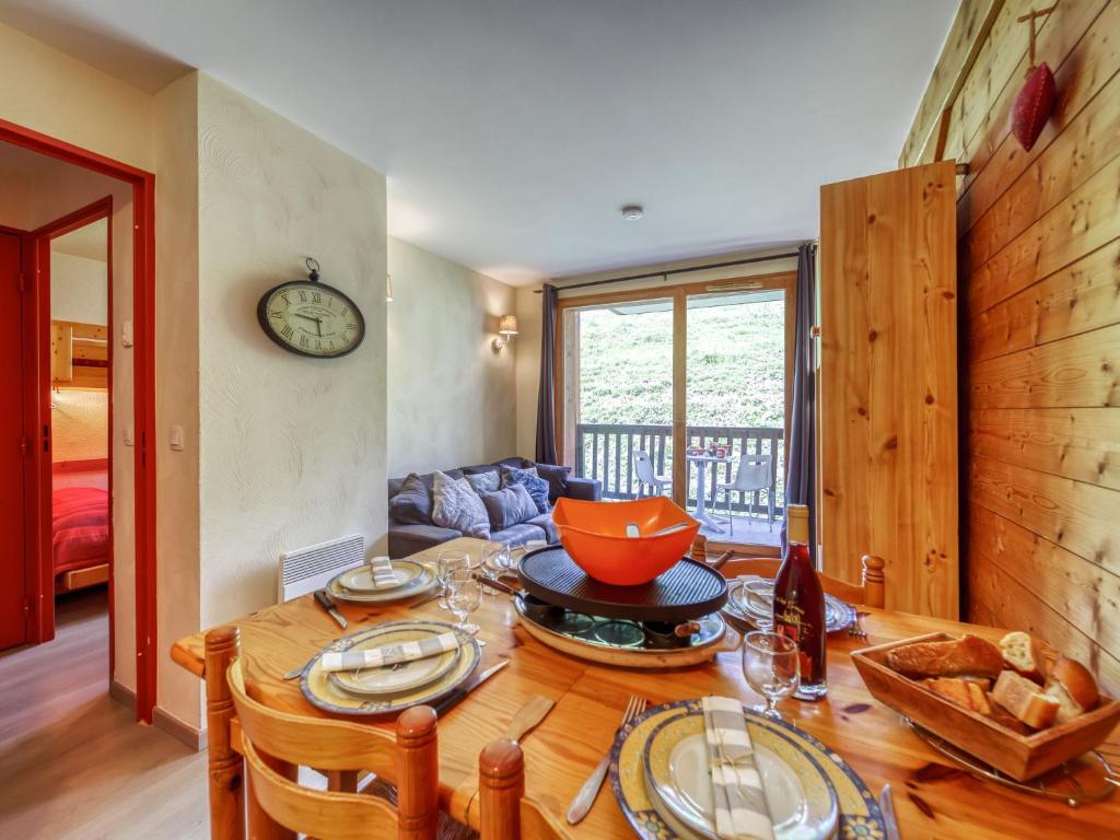 a kitchen and dining room with a wooden table at Apartment Les Alpages du Corbier-1 by Interhome in Le Corbier