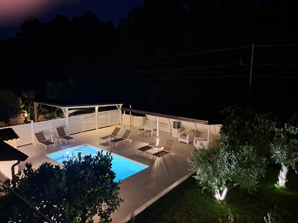 an overhead view of a swimming pool at night at Il Piccolo Principe Relais in Villapiana