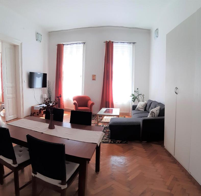 a living room with a table and a couch at Citypark Classic Downtown Apartment in Budapest