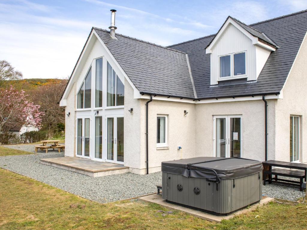 a house with a trash can in front of it at Holiday Home One Mill Lands by Interhome in Uig