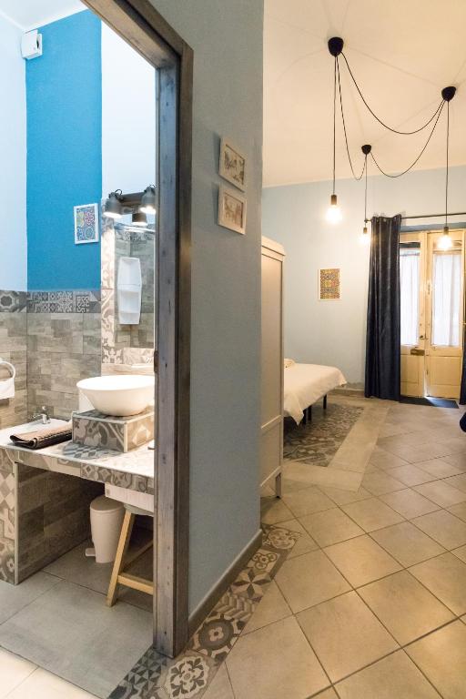 Postel nebo postele na pokoji v ubytování Al Palazzetto di Milo