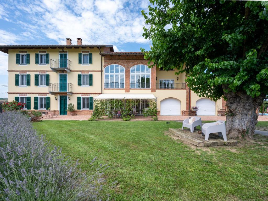 a large house with a tree in the yard at Holiday Home La Bell'aria by Interhome in Tonco