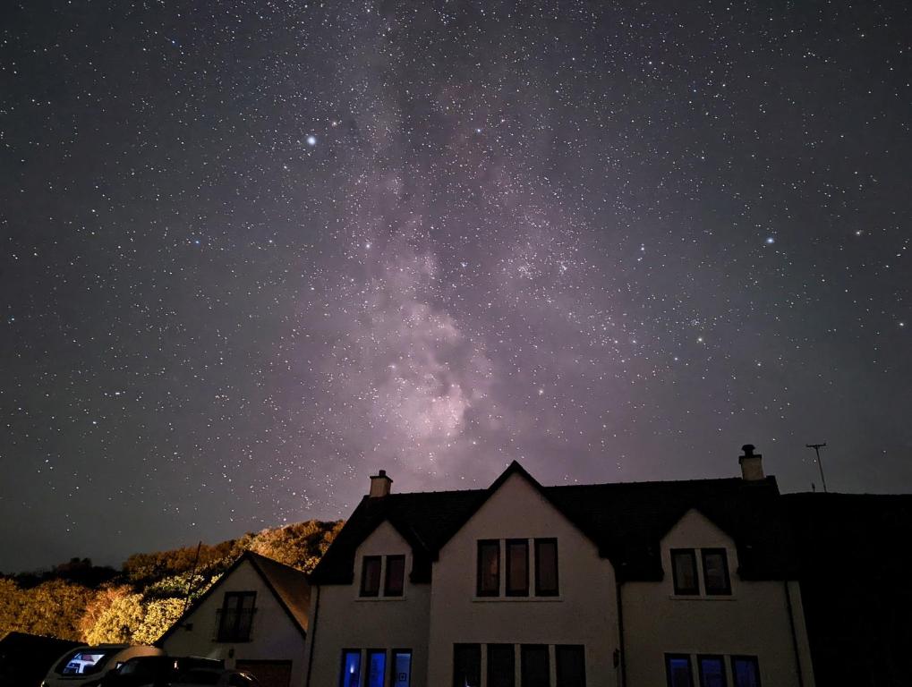 a night view of the milky way over a house at Hazelbank in Colbost