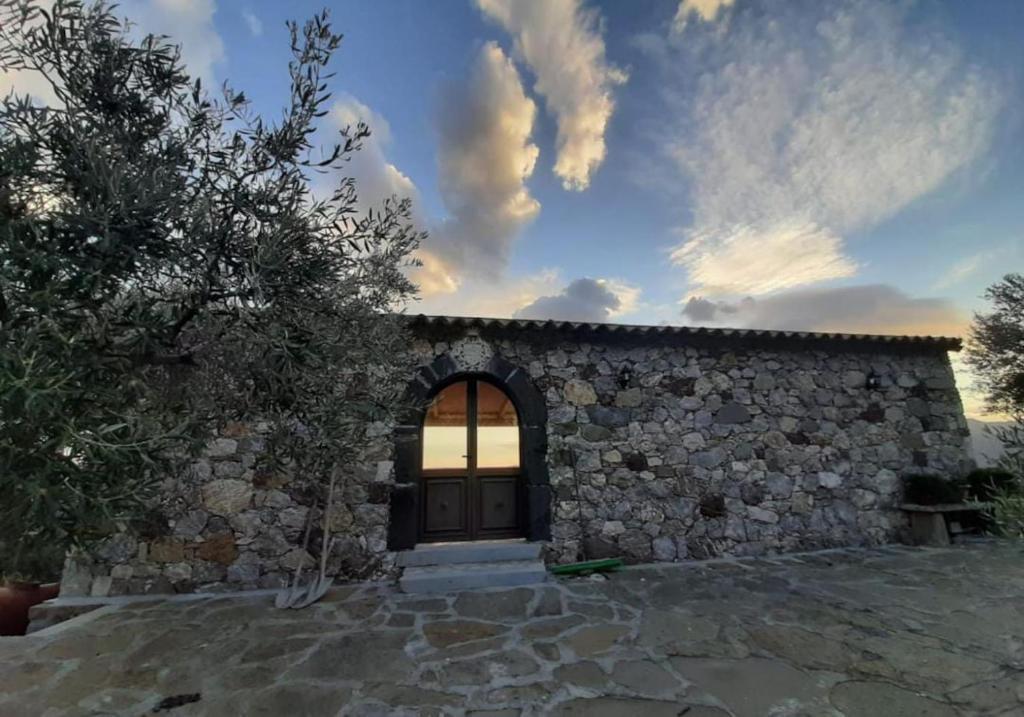 a stone house with a door and a stone wall at Villa Jewels 2 in Gaggi