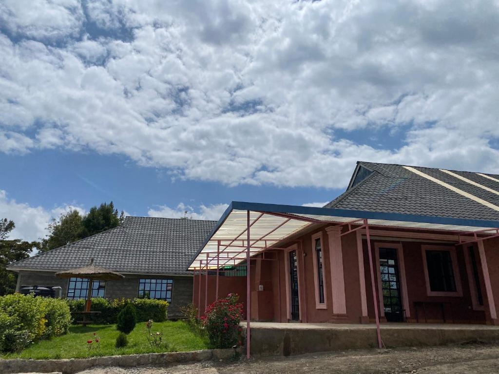 a house with solar panels on the roof at Acacia Gardens Gilgil in Gilgil