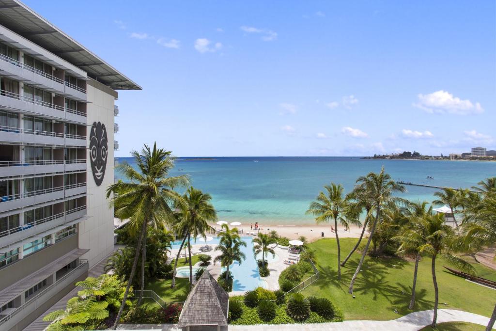 a view of the beach from the balcony of a hotel at Chateau Royal Beach Resort & Spa, Noumea in Noumea