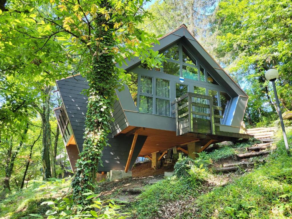 a tree house in the middle of a forest at Chalet Bosco della Bella - Casa 6 - ZUG by Interhome in Termine