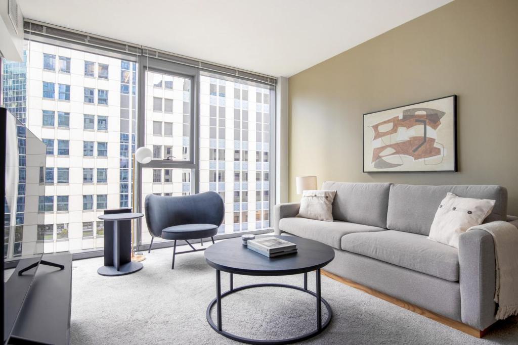 a living room with a couch and a table at Loop 1BR w gym pool lounge 1 block from L CHI-699 in Chicago