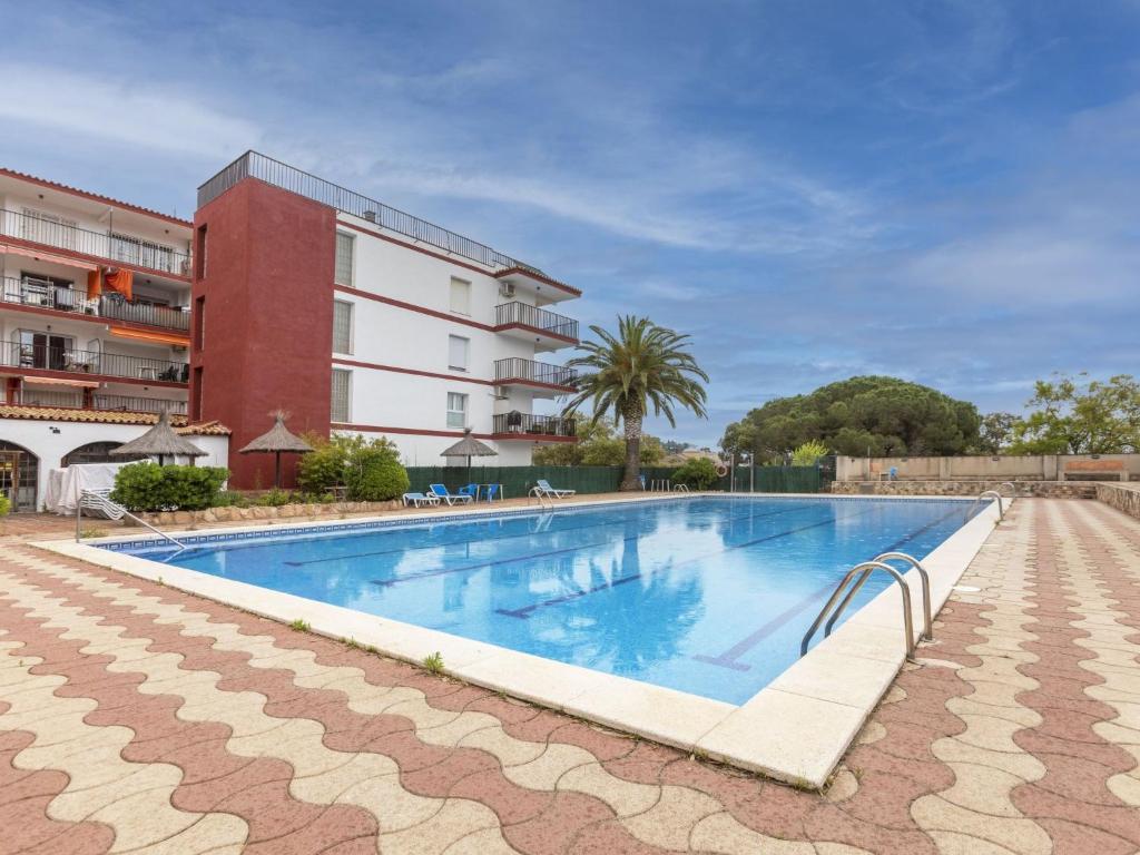 a large swimming pool in front of a building at Apartment Sa Coma by Interhome in Tossa de Mar