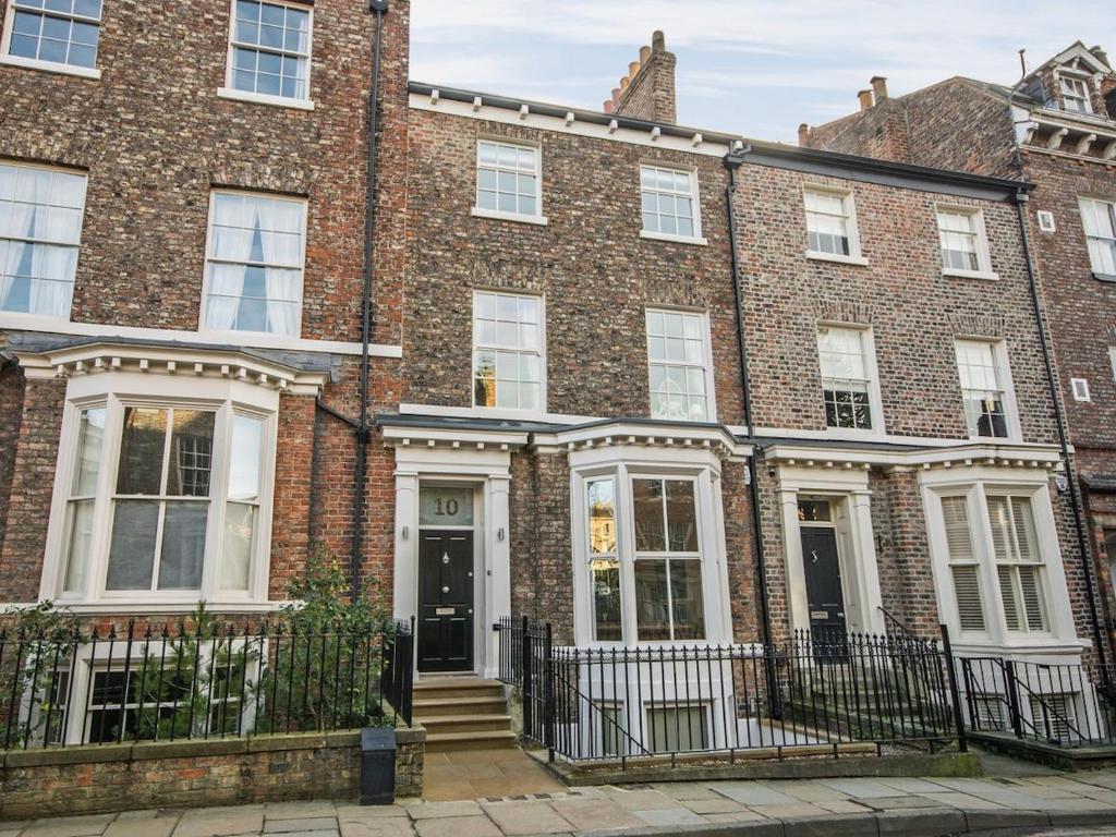 a large brick building with a front door at 10 St Marys in York