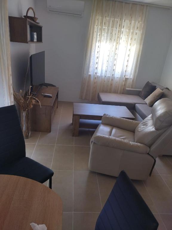 a living room with a couch and a table at Apartments Miličević in Gradac