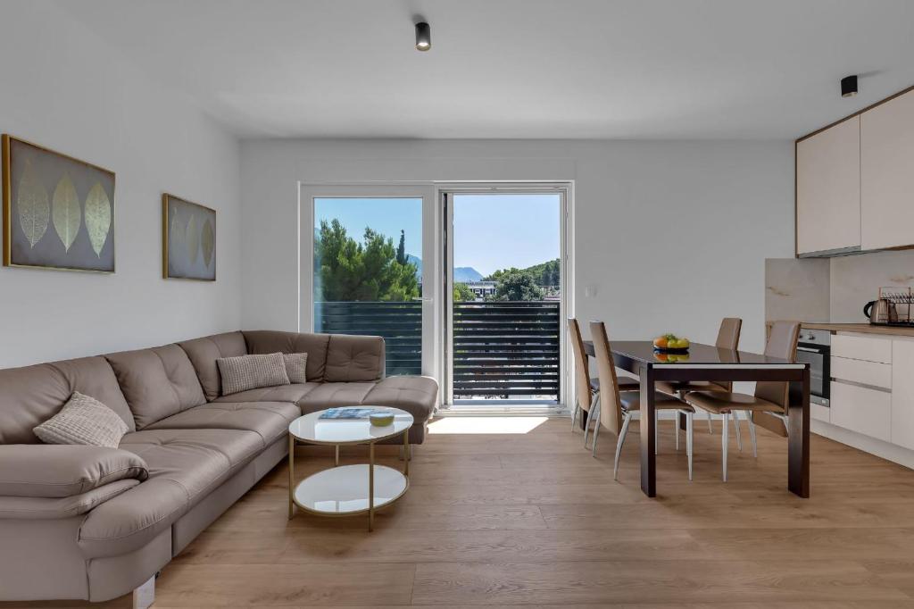 a living room with a couch and a table at Dei apartment in Makarska