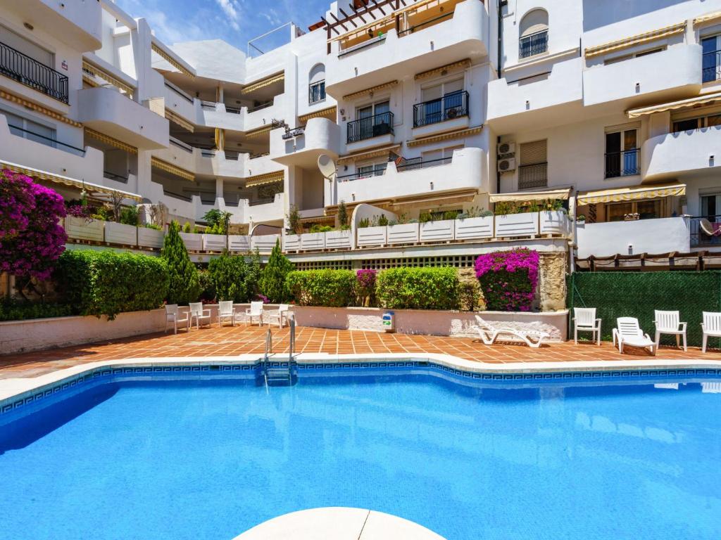 a swimming pool in front of a building at Apartment Atria-3 by Interhome in Torremolinos