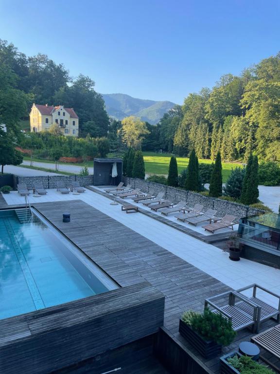 a view of a swimming pool with lounge chairs at Apartment VilaPark 14 in Rogaška Slatina