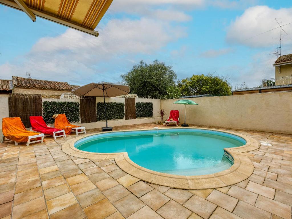 una piscina con 2 sillas y una sombrilla en Holiday Home La Voie Romaine by Interhome, en Sauvian