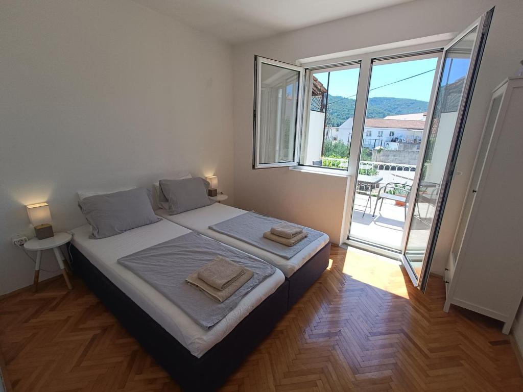 a bedroom with a bed with two towels on it at Holiday House Oleas Stari Grad Hvar - 2 Min To Center Ocean Bus Supermarket in Stari Grad