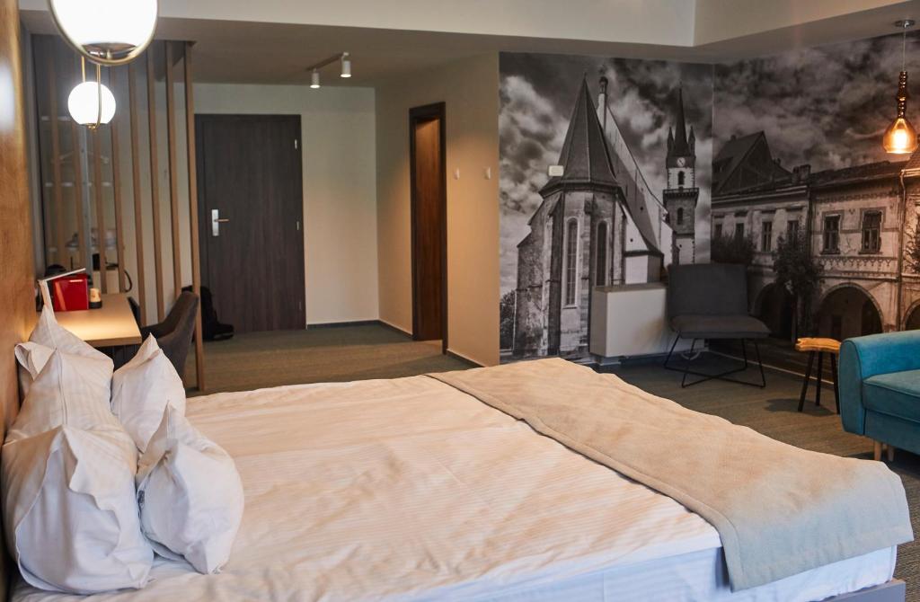 Postel nebo postele na pokoji v ubytování Hotel Bistrita