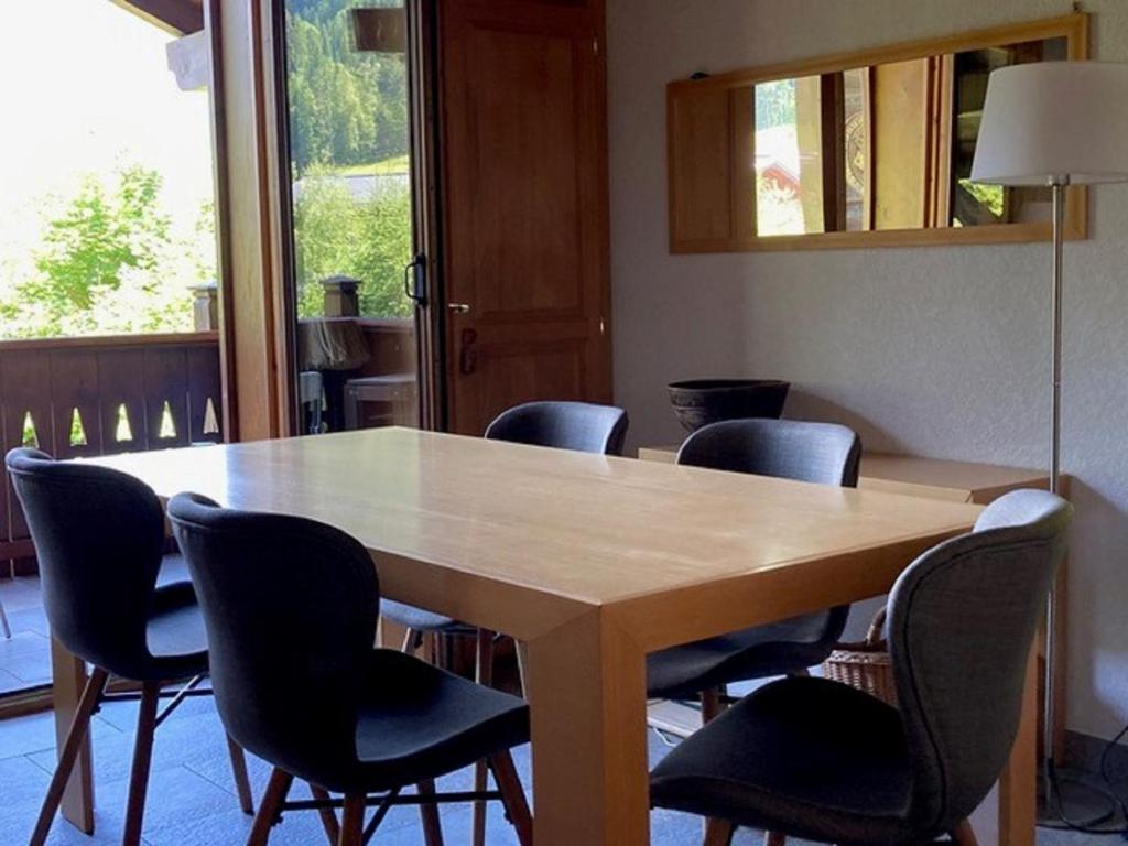 a dining room table with chairs around it at Apartment Village des Oursons Chalet A4 by Interhome in Chamonix