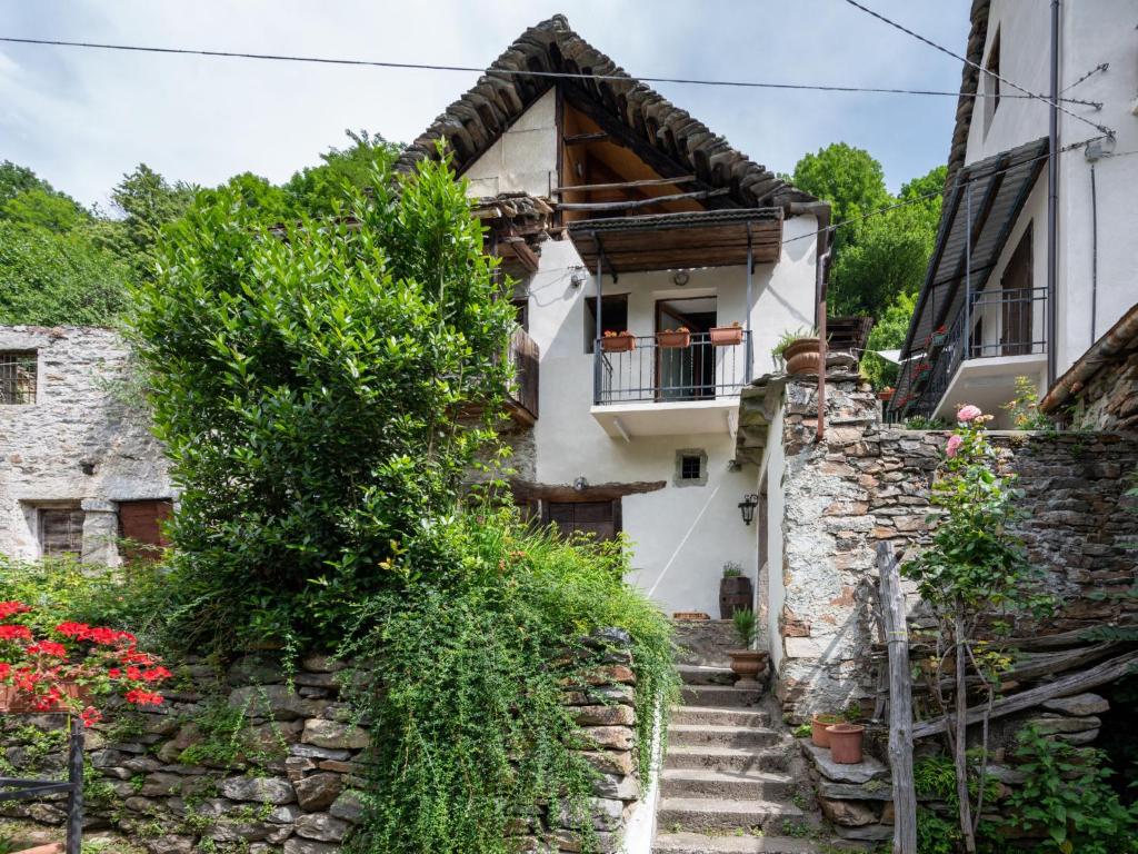 an old house with a staircase leading up to it at Chalet Il Gianlupo Grigio by Interhome in Bognanco