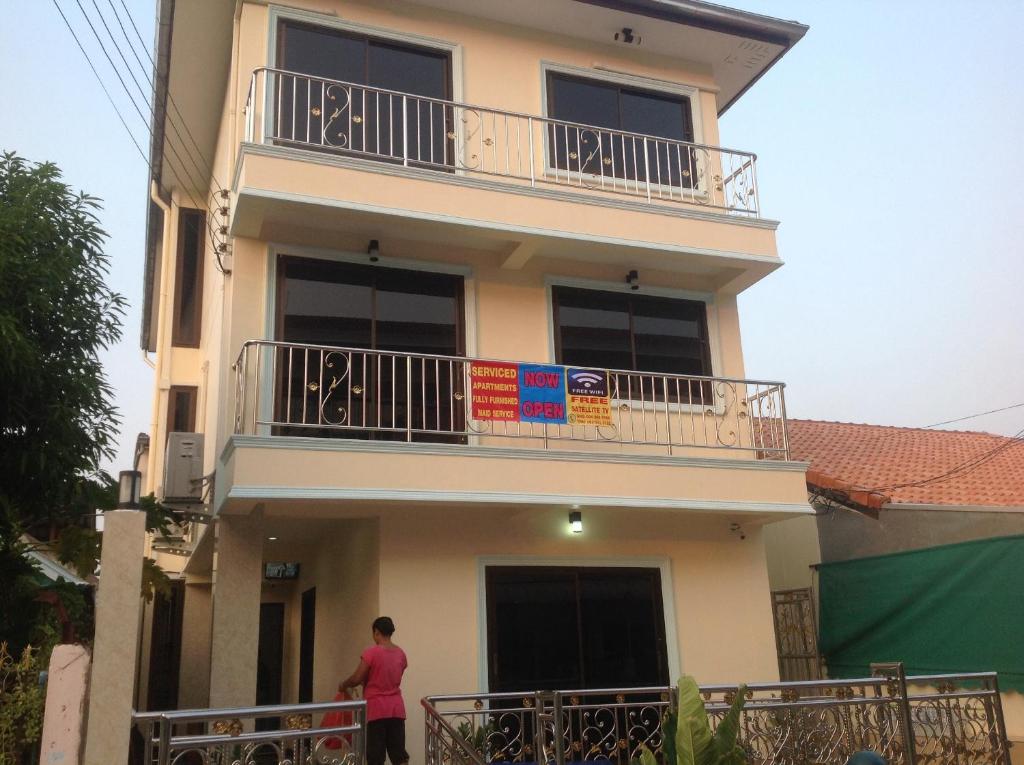 a person standing in front of a building at Junior Apartment in Pattaya