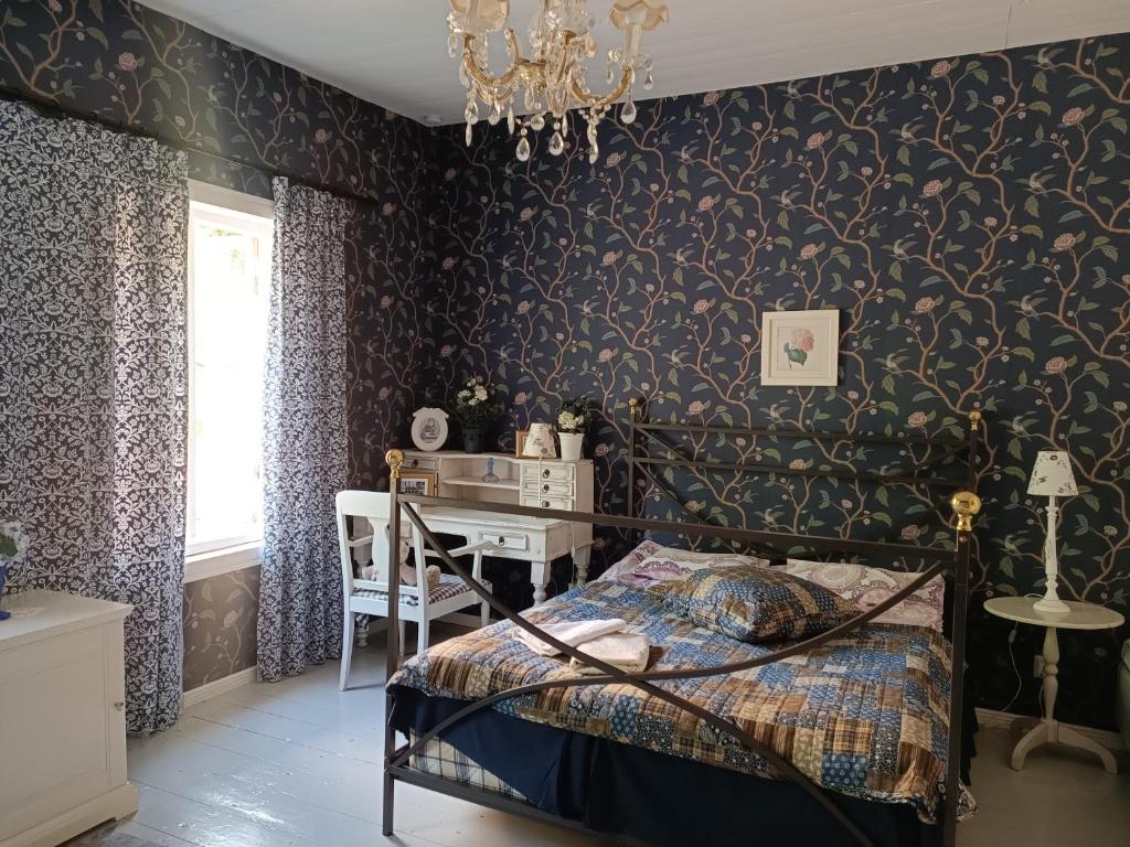 a bedroom with a bed and a desk in it at VILLA REBECCA in Naantali