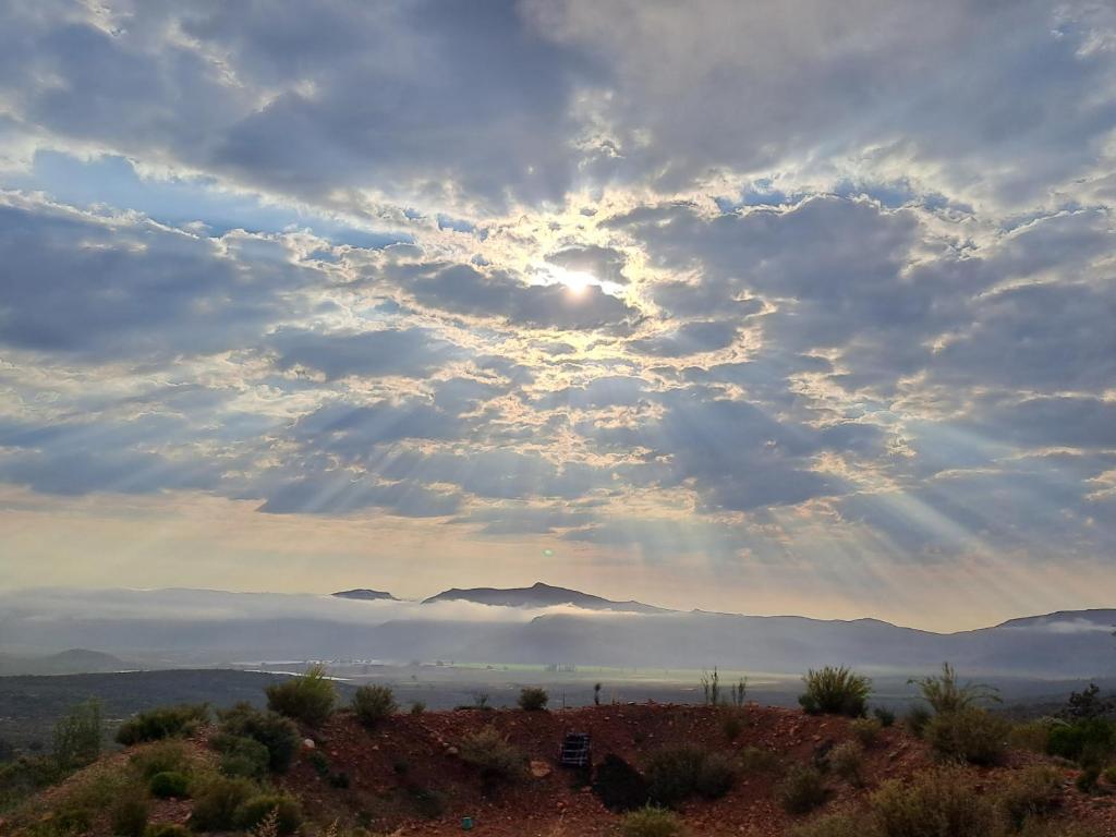 a cloudy sky with the sun in the middle at Rangers Reserve in Touwsrivier