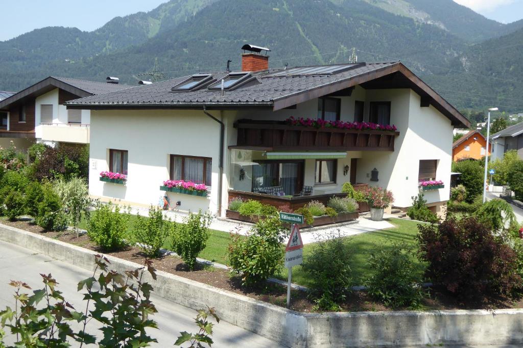 a house with a solar roof on a street at Fewo Schrottenbaum in Bürs