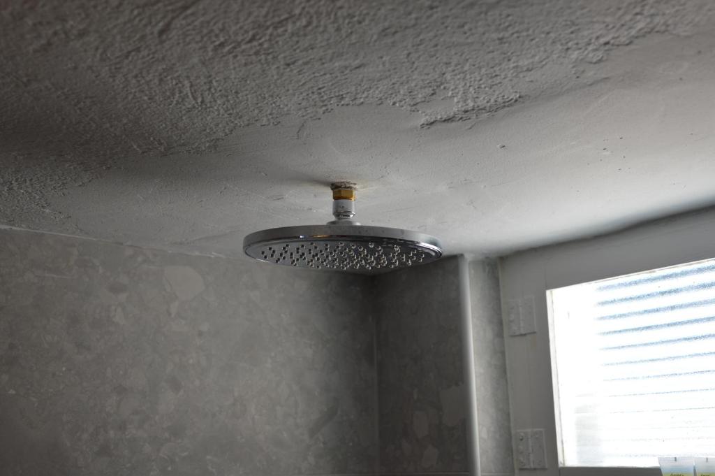 a ceiling with a light in a room with a window at Summer Residence in Provatas