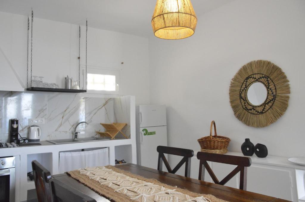 a kitchen with a table and chairs and a mirror at Summer Residence in Provatas