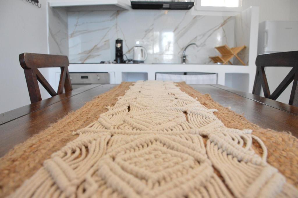 a knitted rug on a wooden table in a kitchen at Summer Residence in Provatas