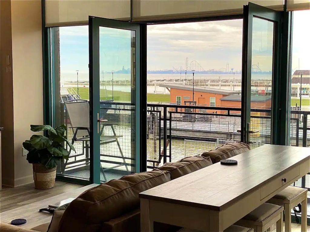 a living room with a couch and a large window at Condo with Lake & Cedar Point Views From Balcony. in Sandusky