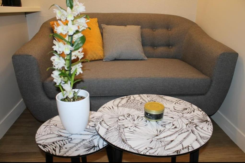 a living room with a couch and a coffee table at Zenitude Place in Margny-lès-Compiègne