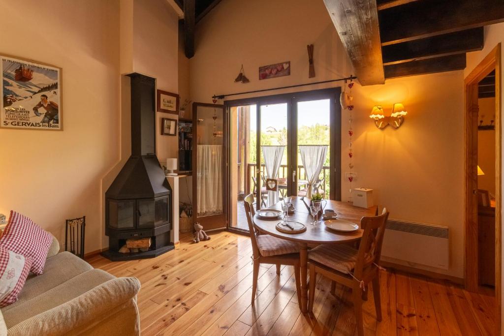 Un comedor con mesa y chimenea. en Duplex la Solana, en Err