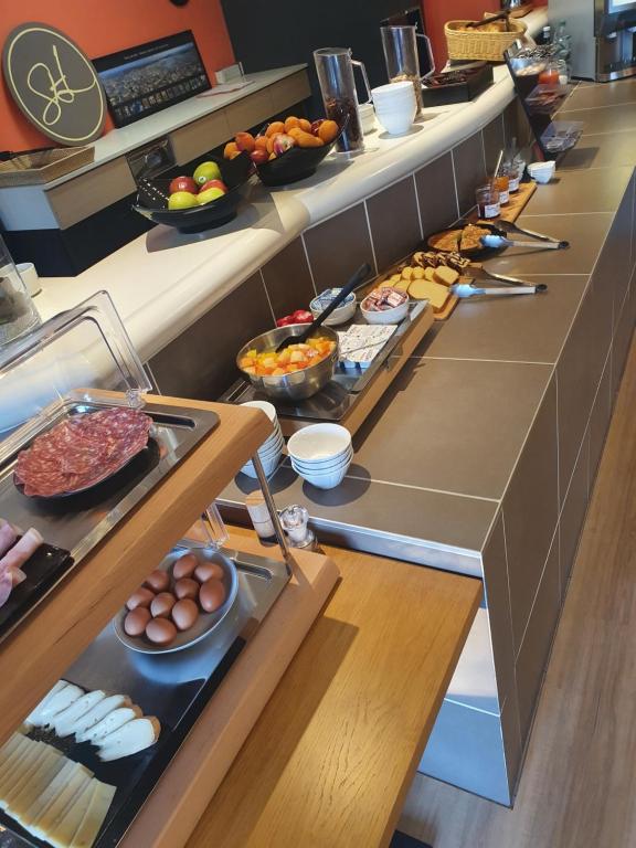 a buffet line with many different types of food at Hotel Salea in Pornic